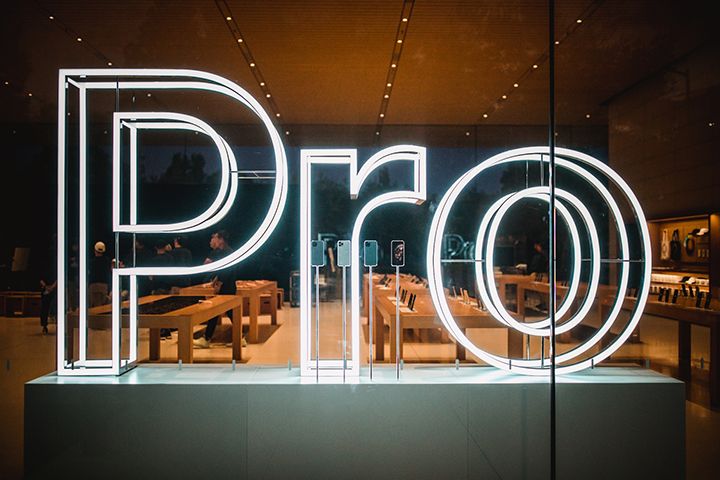 Neon sign in office space that reads, "Pro"