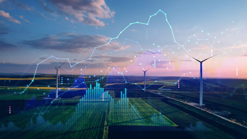 A landscape image of wind turbines with a stock ticker overlay across an agricultural field